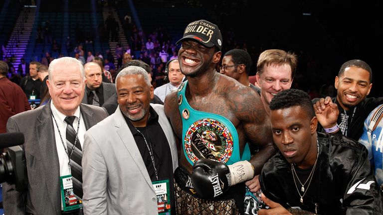  Deontay Wilder poses with members of his camp after defeating WBC heavyweight champion Bermane Stiverne