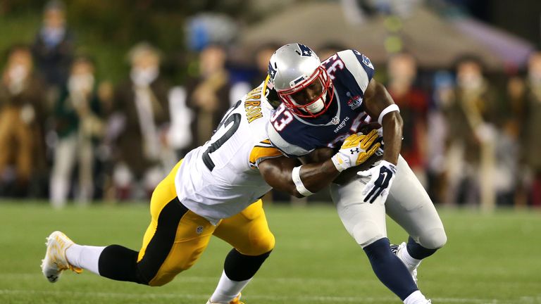 Dion Lewis #33 of the New England Patriots runs with the ball against  James Harrison #92 of the Pittsburgh Steelers