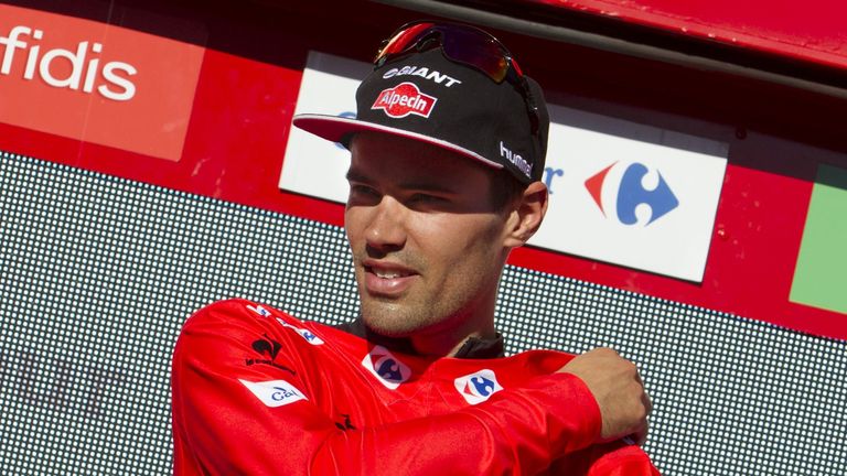 Giant-Alpecin's Dutch cyclist Tom Dumoulin puts on the red jersey on the podium after the18th stage of the 2015 Vuelta Espana