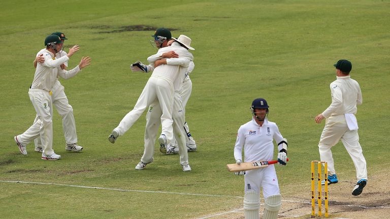 Nathan Lyon of Australia is congratulated by team mates after taking the wicket of Graeme Swann of England in Perth, 2013