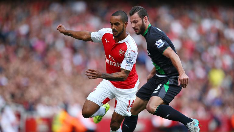 Theo Walcott of Arsenal is closed down by Erik Pieters of Stoke City