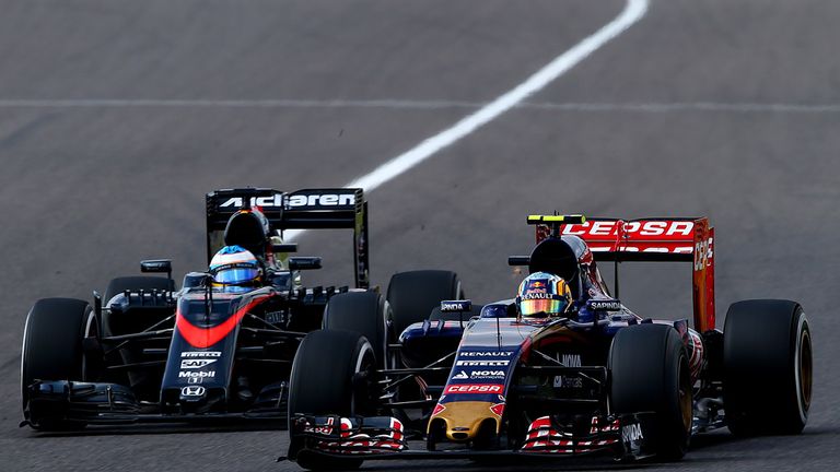 Carlos Sainz (r) passes Fernando Alonso during the Japanese Grand Prix