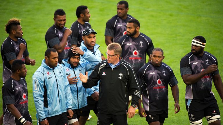 Fiji's manager John McKee (middle) speaks to Fiji's flanker and captain Akapusi Qera (second left)