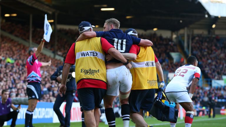 Finn Russell of Scotland leaves the field injured