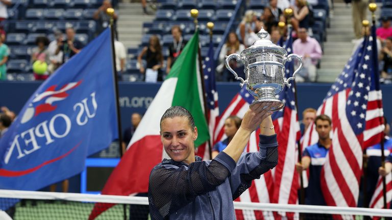 Flavia Pennetta of Italy celebrates with the winner's trophy after defeating Roberta Vinci of Italy