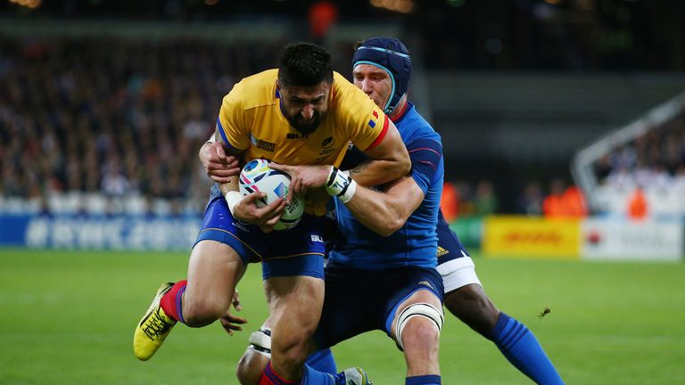 Florin Vlaicu of Romania is tackled by Bernard Le Roux of France 
