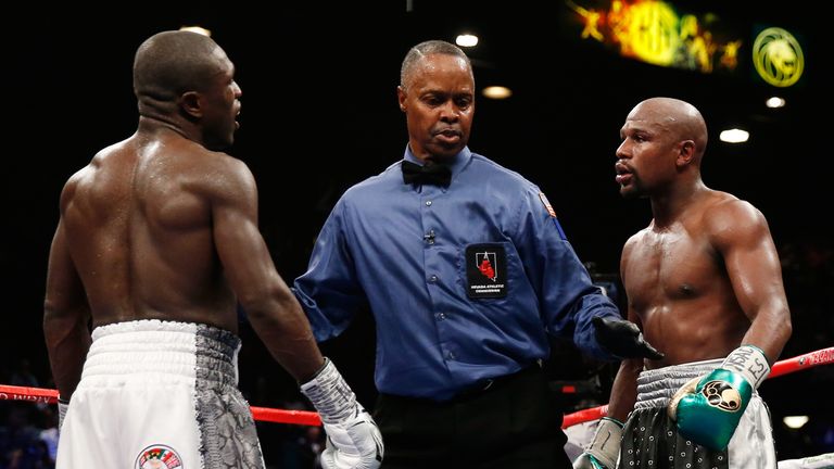 Floyd Mayweather Jr. and Andre Berto stare each other down at the end of the round during their WBC/WBA welterweight title fight