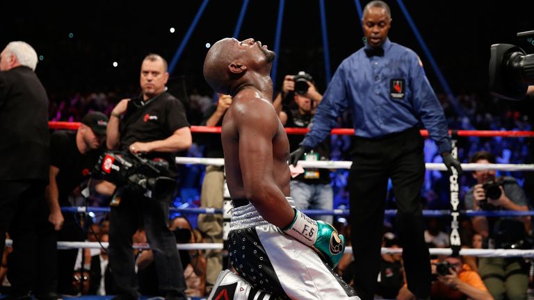 Floyd Mayweather kneels on the mat after beating Andre Berto in what he says will be his final fight