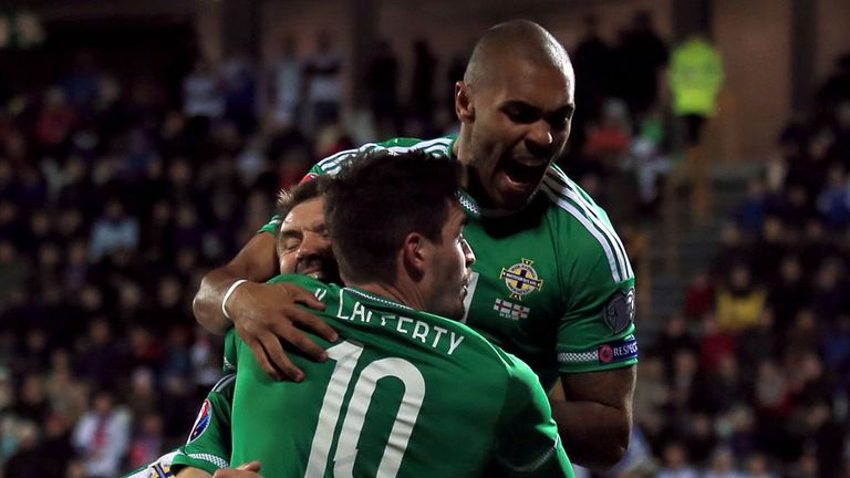 Northern Ireland's Gareth McAuley (partially hidden centre group) celebrates scoring his side's second goal