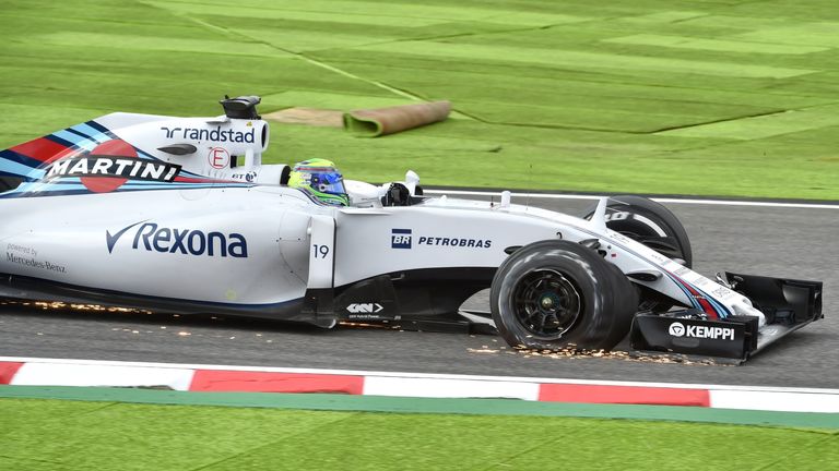 Felipe Massa of Brazil drives his damaged car on the first lap