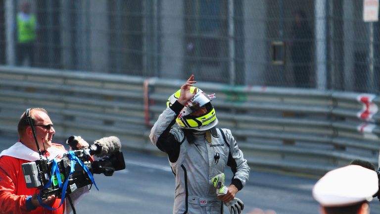 Jenson Button runs to the podium after parking in the wrong place in Monaco