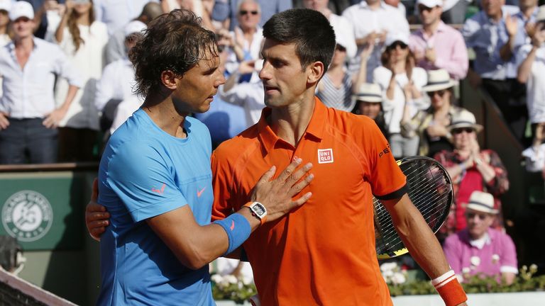 Rafael Nadal and Novak Djokovic embrace after the Serb inflicts only Nadal's second ever defeat at Roland Garros
