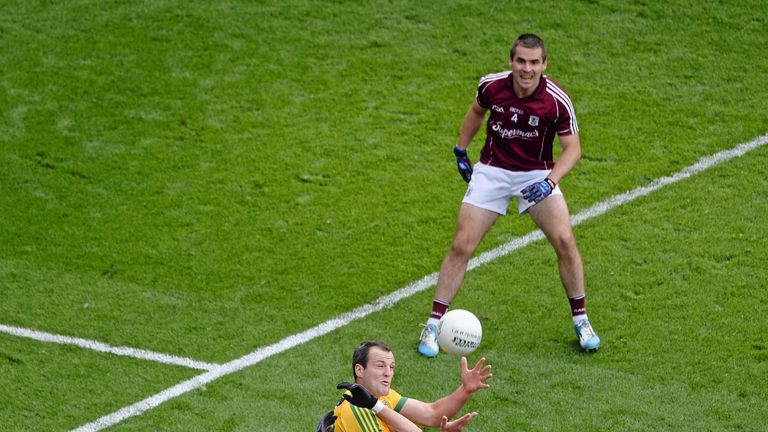 Michael Murphy rises above Galway defender Finian Hanley to catch the ball before scoring a point