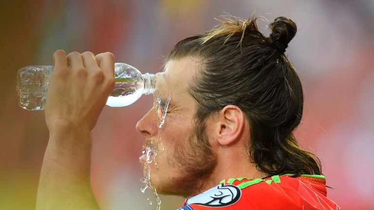 Gareth Bale of Wales douses hmself with water during the European Qualifier with Israel