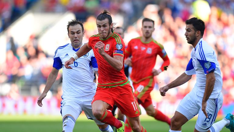 Gareth Bale of Wales is closed down by Bibras Natkho (L) of Israel and Orel Ogani (R) of Israel