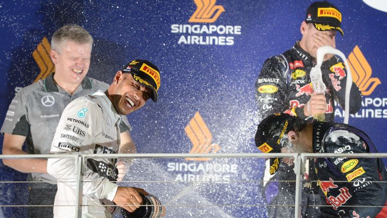 Lewis Hamilton sprays a bottle of champagne