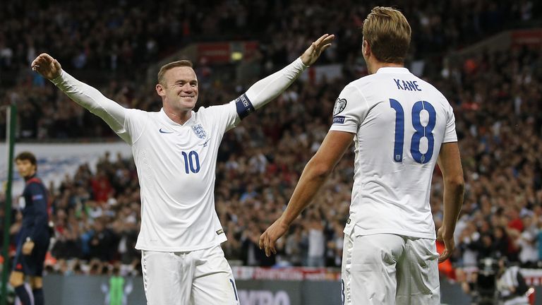 England striker Wayne Rooney (L) reacts as England's Harry Kane celebrates scoring v Switzerland