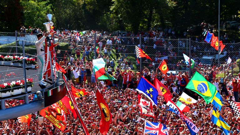 Lewis Hamilton celebrates on the podium next to Sebastian Vettel after the Italian GP