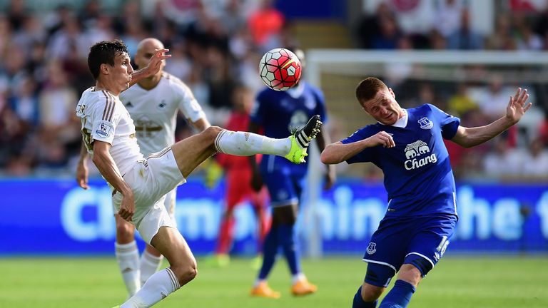 Jack Cork and James McCarthy compete for the ball