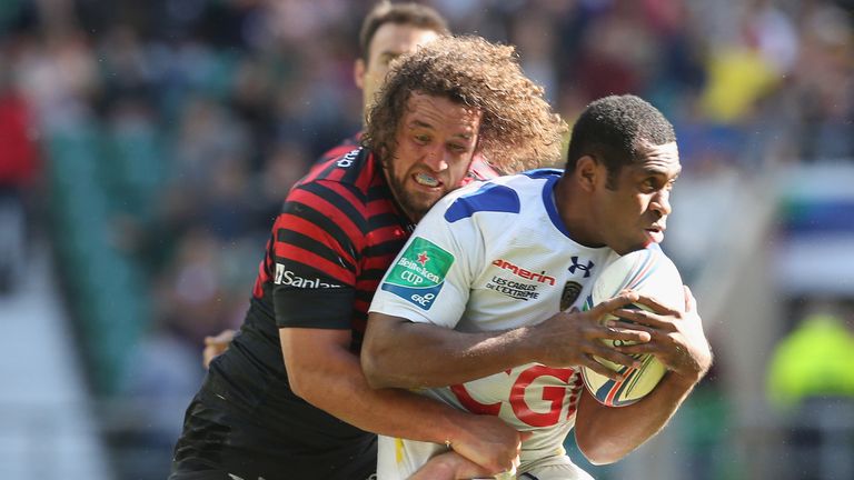 Sitiveni Sivivatu of Clermont is tackled by Jacques Burger of Saracens during the Heineken Cup semi final match