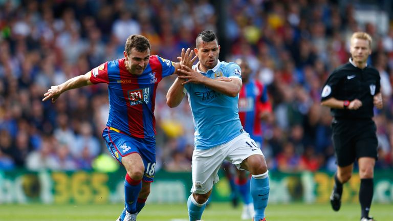 James McArthur of Crystal Palace is challenged by Sergio Aguero of Manchester City