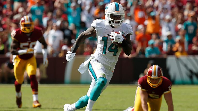 Wide receiver Jarvis Landry #14 of the Miami Dolphins carries the ball for a second half touchdown during a game against the W