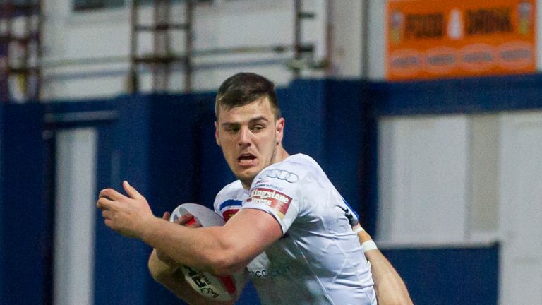 Wakefield's Joe Arundel is tackled by Halifax's Andy Bracek.