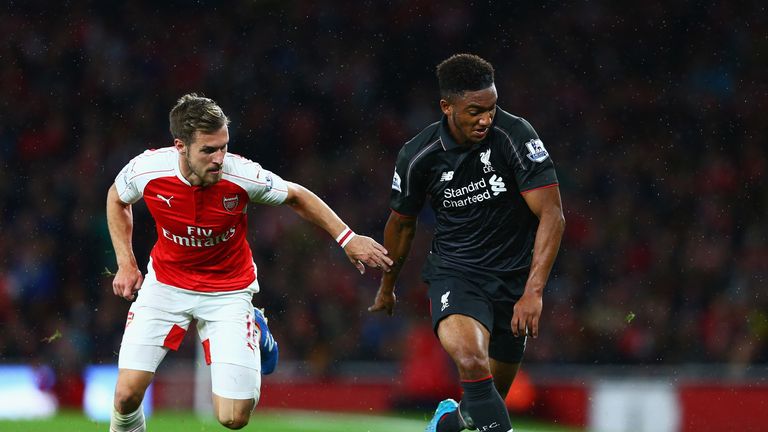 Joe Gomez of Liverpool is challenged by Aaron Ramsey of Arsenal during the Premier League match at Emirates Stadium on August 24, 2015 in London, England.