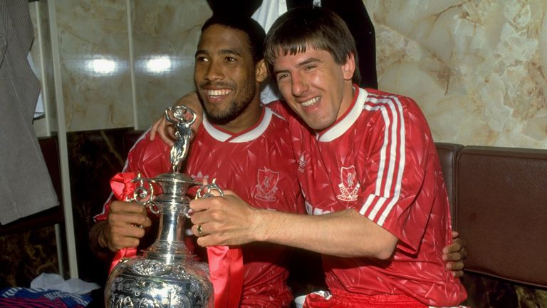 1 May 1990:  John Barnes and Peter Beardsley of Liverpool celebrate with the Division 1 trophy