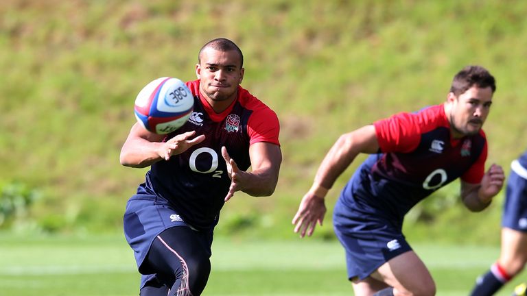 Jonathan Joseph catches the ball watched by Brad Barritt during an England training session