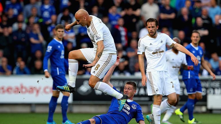 Jonjo Shelvey is tackled by James McCarthy