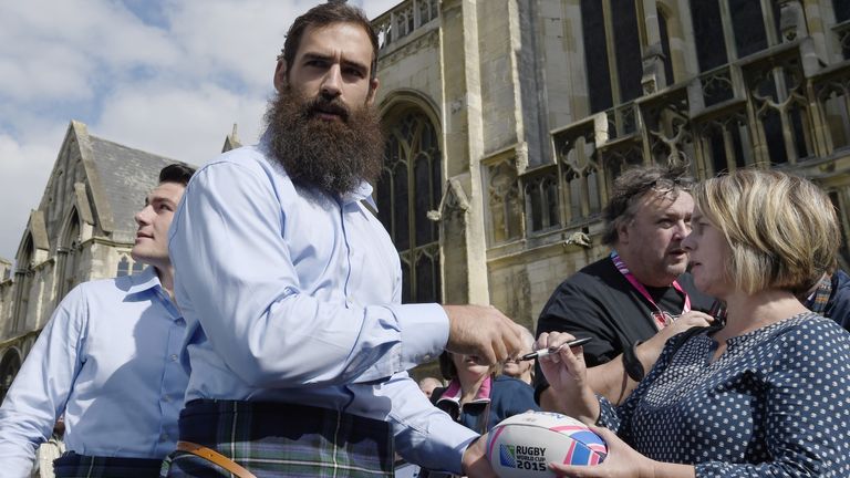 josh Strauss  signs autographs with team mates for Scotland's official welcoming ceremony  at the Gloucester Cathedral