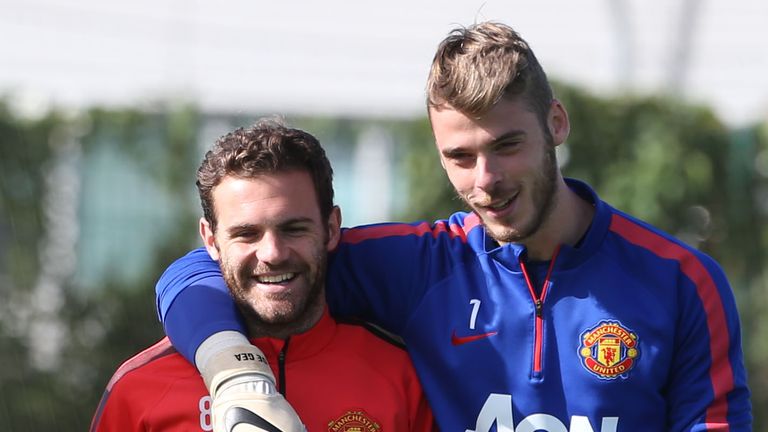 Juan Mata and David de Gea of Manchester United in action during a first team training session.