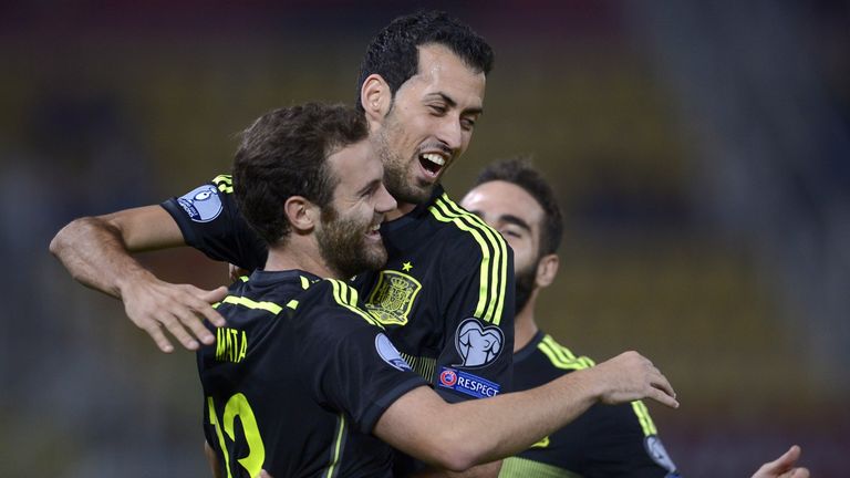 Spain's Juan Mata celebrates with his team-mate Sergio Busquets after scoring during the European Qualifier v Macedonia at the Filip II Arena in Skopje