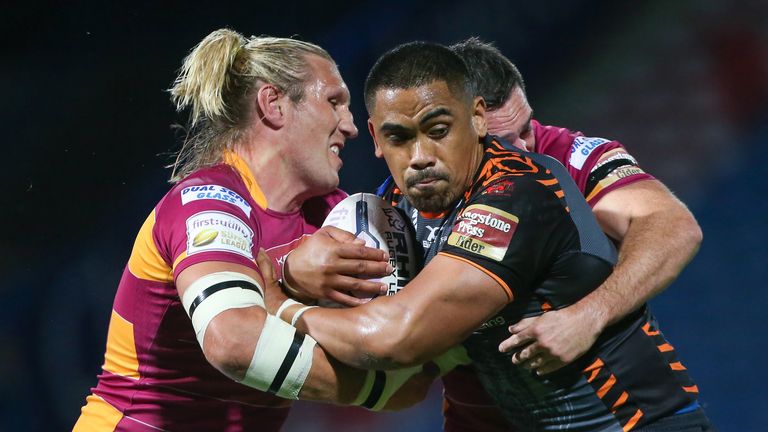 Castleford's Junior Moors is tackled by Huddersfield's Eorl Crabtree and Joe Wardle.