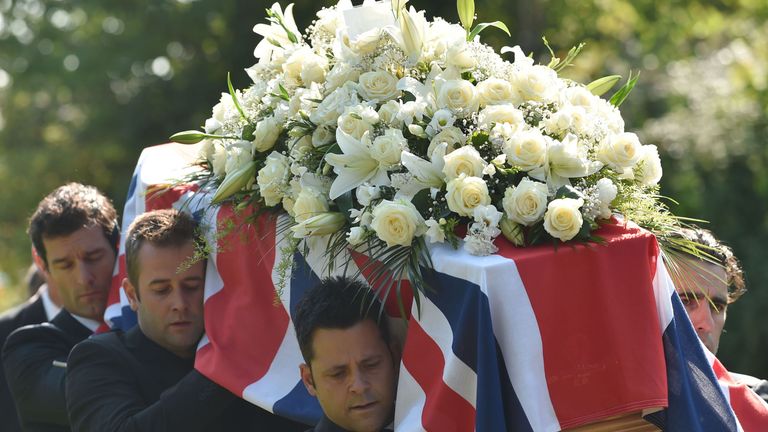 The coffin of Indycar racer Justin Wilson is carried by Mark Webber (far left) and Dario Franchetti (right) during his funeral at St James the Great Church