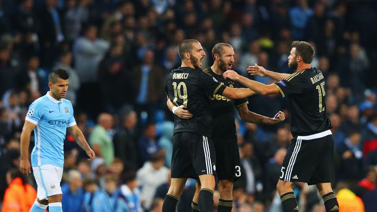 Juventus celebrate victory as Sergio Aguero of Manchester City looks dejected