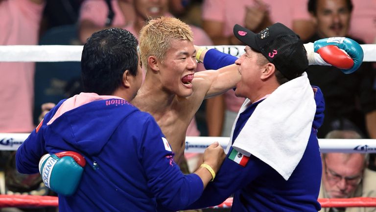 Tomoki Kameda (C) celebrates his seventh-round knockout victory over Pungluang Singyu to retain his WBO bantamweight title