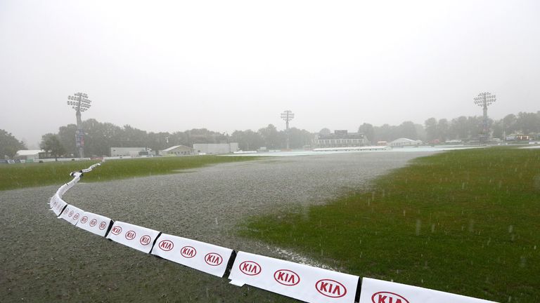 Torrential rain falls as large puddles of water collect on the outfield at Canterbury