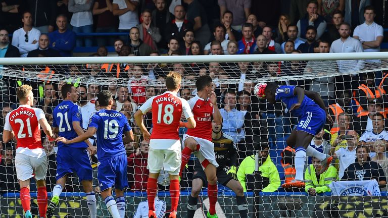Chelsea's French defender Kurt Zouma (R) heads the opening goal of the English Premier League football match between Chelsea and Arsenal at Stamford Bridge