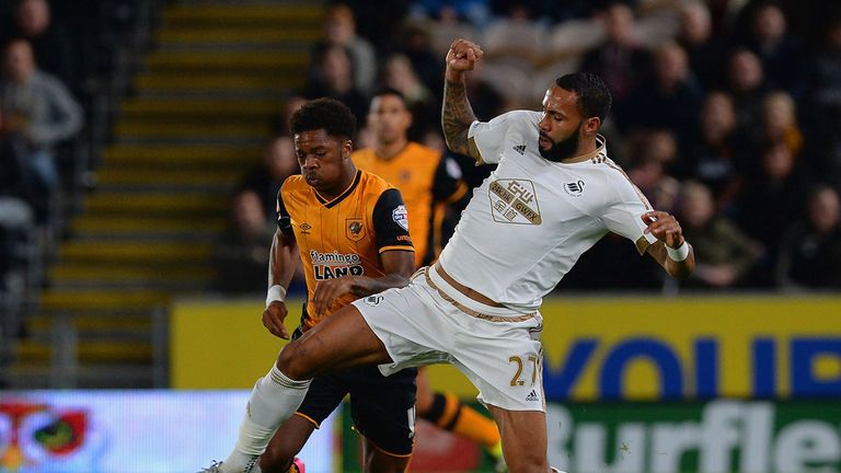 Kyle Bartley of Swansea City tackles Chuba Akpom of Hull City