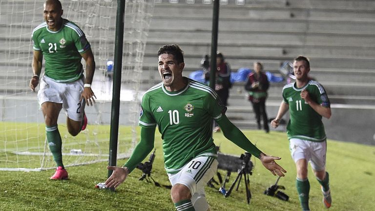 Northern Ireland's striker Kyle Lafferty (C) celebrates after scoring their late equaliser during the Euro 2016 qualifying group F