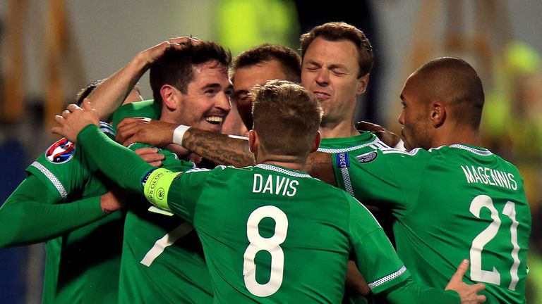 Northern Ireland's Kyle Lafferty (left huddle) celebrates scoring his side's third goal of the game 