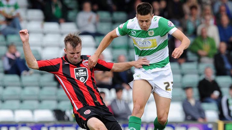 Harry Cornick of Yeovil is tackled by Morecambe's Laurence Wilson
