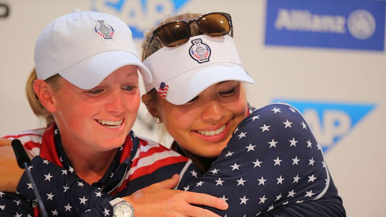 Alison Lee (R) of the United States Team hugs her teammate Stacy Lewis (L) at the press conference after winning the Solheim Cup