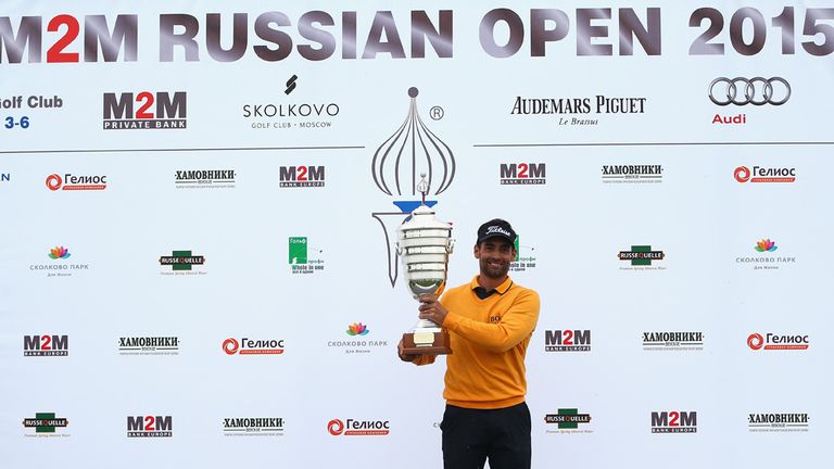 Lee Slattery of England poses for photographs with the trophy after winning the M2M Russian Open at Skolkovo Golf Club on S