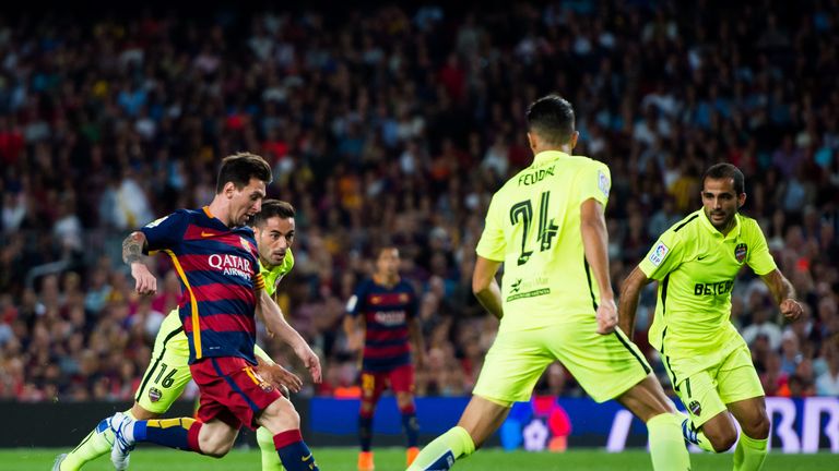 BARCELONA, SPAIN - SEPTEMBER 20: Barcelona runs with the ball next to Angel Trujillo