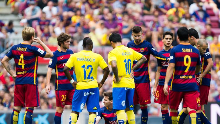 Lionel Messi receives treatment after he is injured against Las Palmas