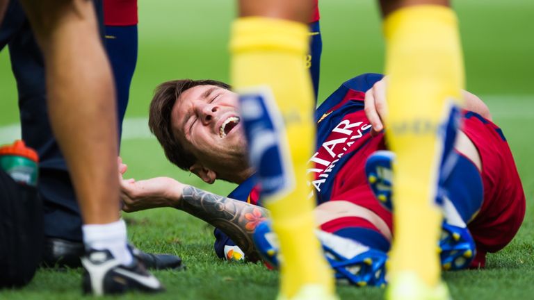 Lionel Messi is injured during Barcelona's game against Las Palmas