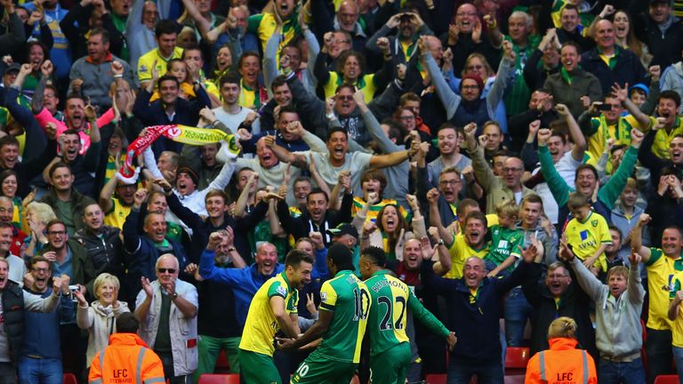 Russell Martin celebrates with teammates in front of the travelling fans